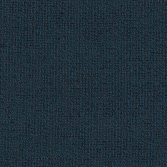 Teal-blue fabric texture, granular surface with dark gray flecks, matte finish, densely packed irregular elements, woven appearance.